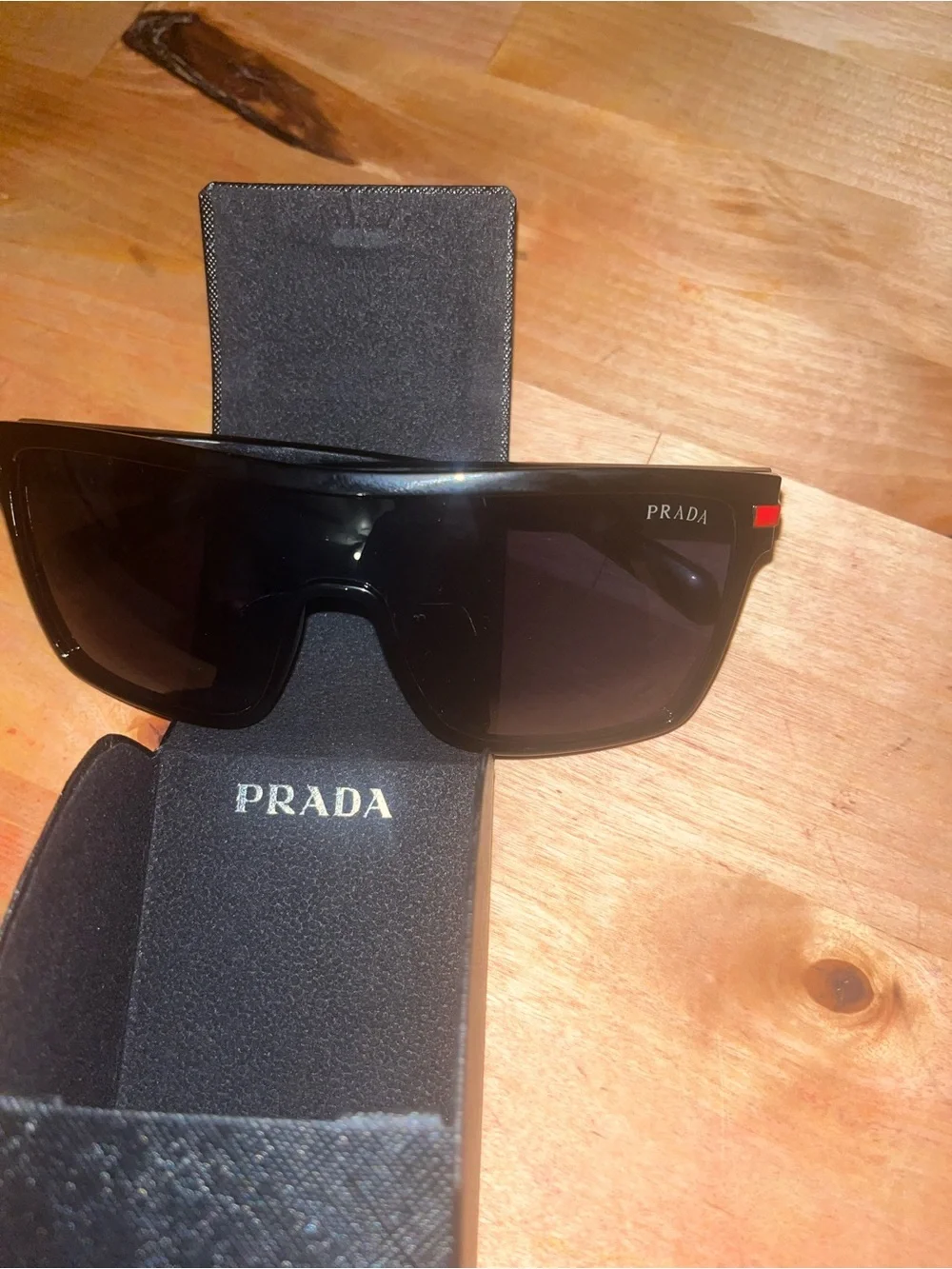 Prada Black Sunglasses with Subtle Red Accents